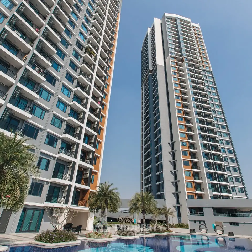 Luxurious high-rise apartment buildings with a stunning pool and lush landscaping.