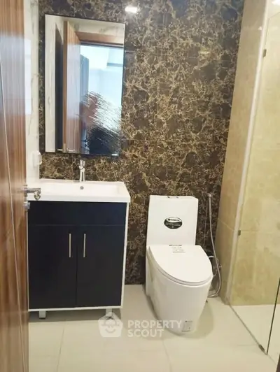 Modern bathroom with elegant marble wall and sleek fixtures