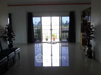 Spacious living room with large windows and elegant decor