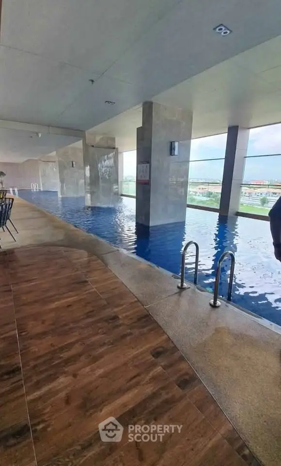 Luxurious indoor pool with stunning city views and modern design, perfect for relaxation and leisure.