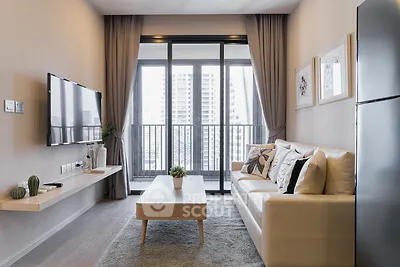 Modern living room with balcony view, stylish decor, and natural light.
