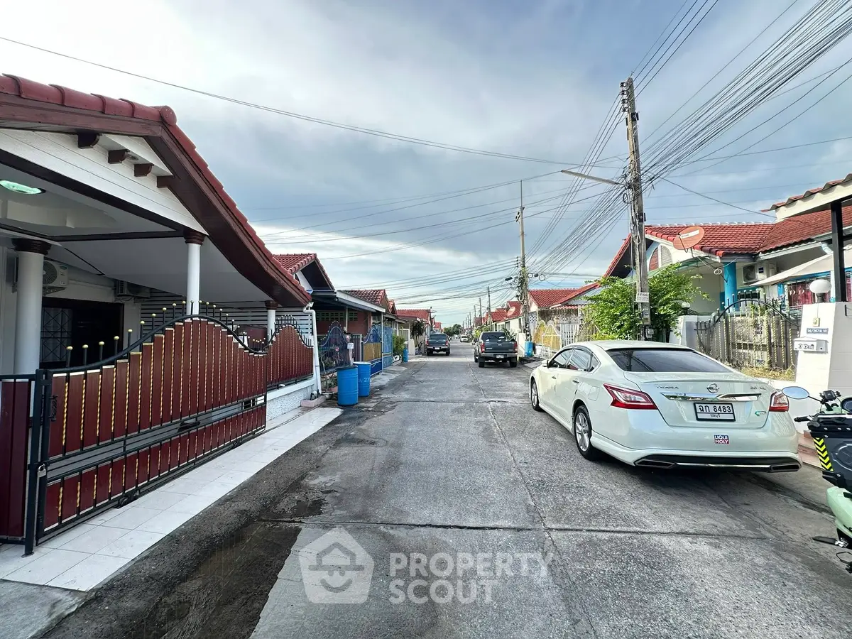 Charming suburban street with modern houses and parked cars, ideal for family living.