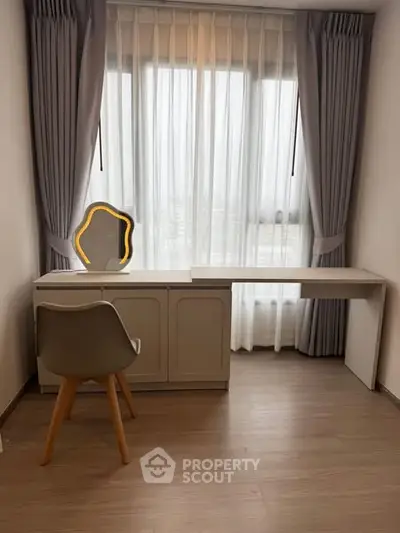 Modern study room with sleek desk and stylish chair, featuring large window with elegant curtains.