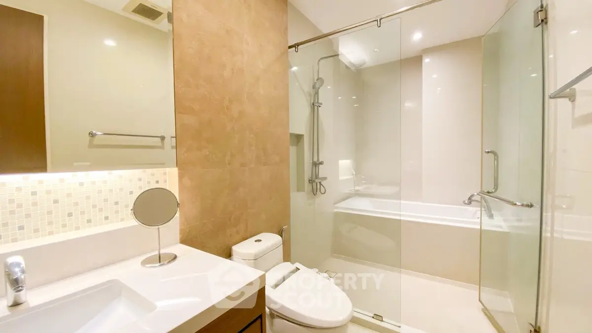 Luxurious modern bathroom with glass shower and elegant fixtures