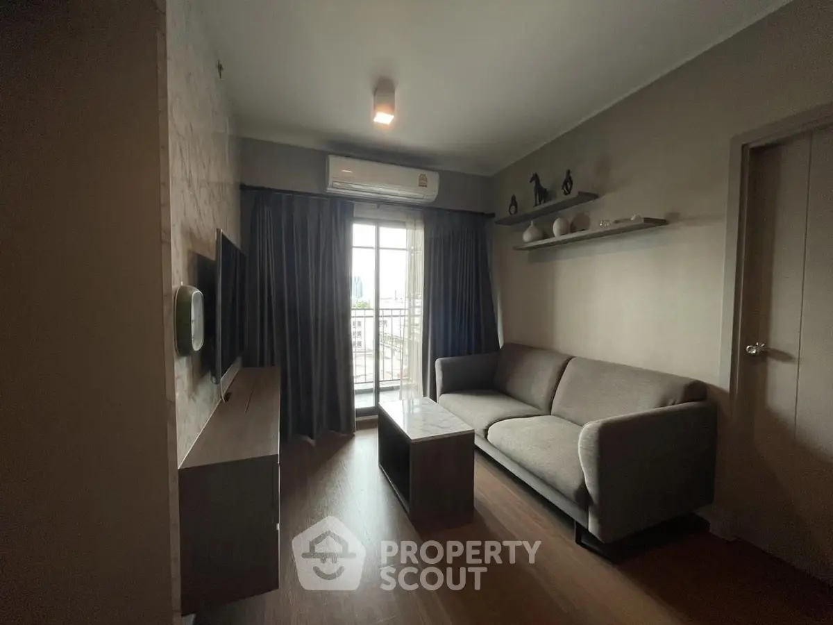 Modern living room with cozy sofa and large window offering city view