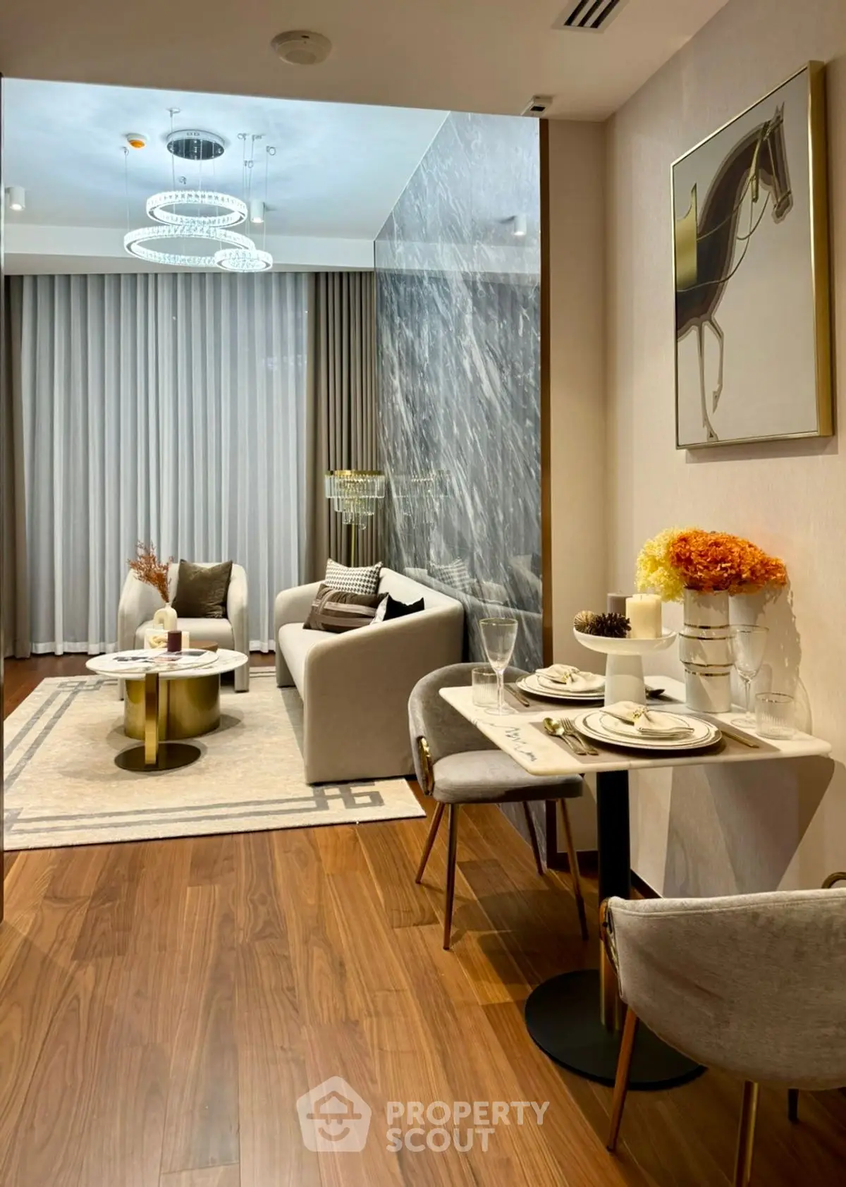 Luxurious modern living room with elegant decor and stylish furniture, featuring a cozy dining area.
