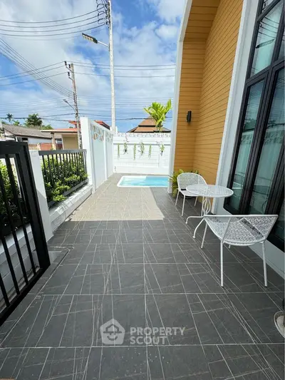 Charming patio with pool and seating area in modern home exterior