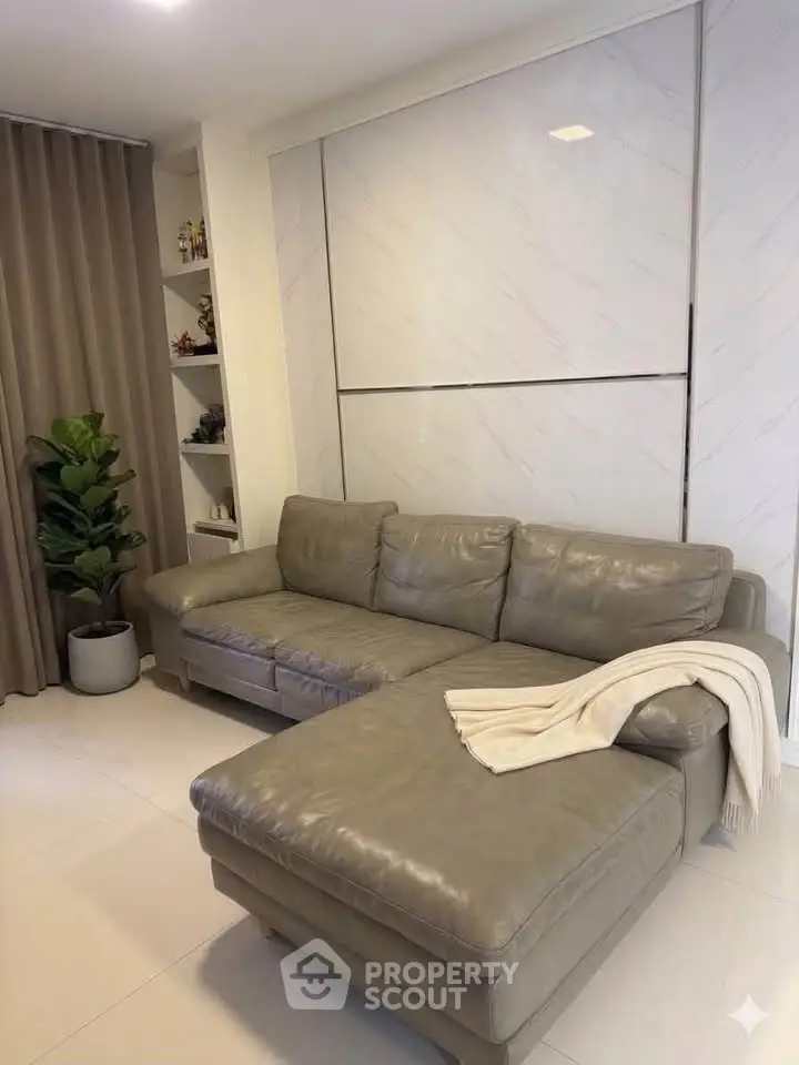 Modern living room with stylish gray leather sectional sofa and elegant decor