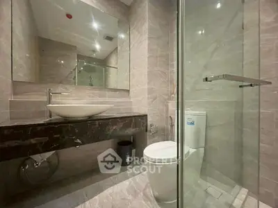 Modern bathroom with sleek design, glass shower, and elegant fixtures in a luxury apartment.
