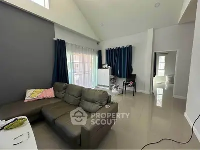 Spacious living room with modern decor and large windows for natural light