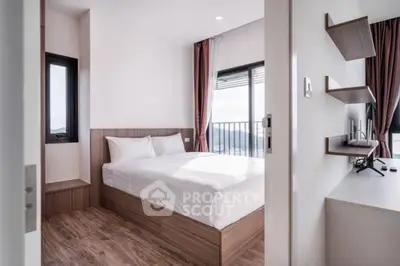 Modern bedroom with wooden flooring and balcony view