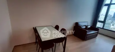 Spacious living room with city view, featuring modern dining set and cozy seating area.