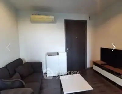 Modern living room with sleek furniture and air conditioning unit