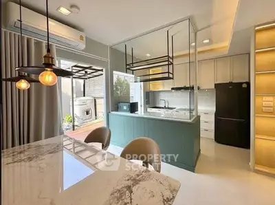 Modern kitchen with marble dining table and sleek appliances in open layout