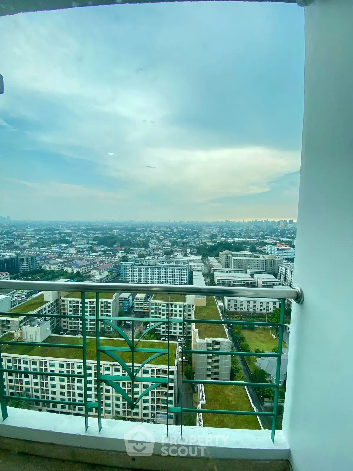 Stunning high-rise balcony view of cityscape with expansive skyline