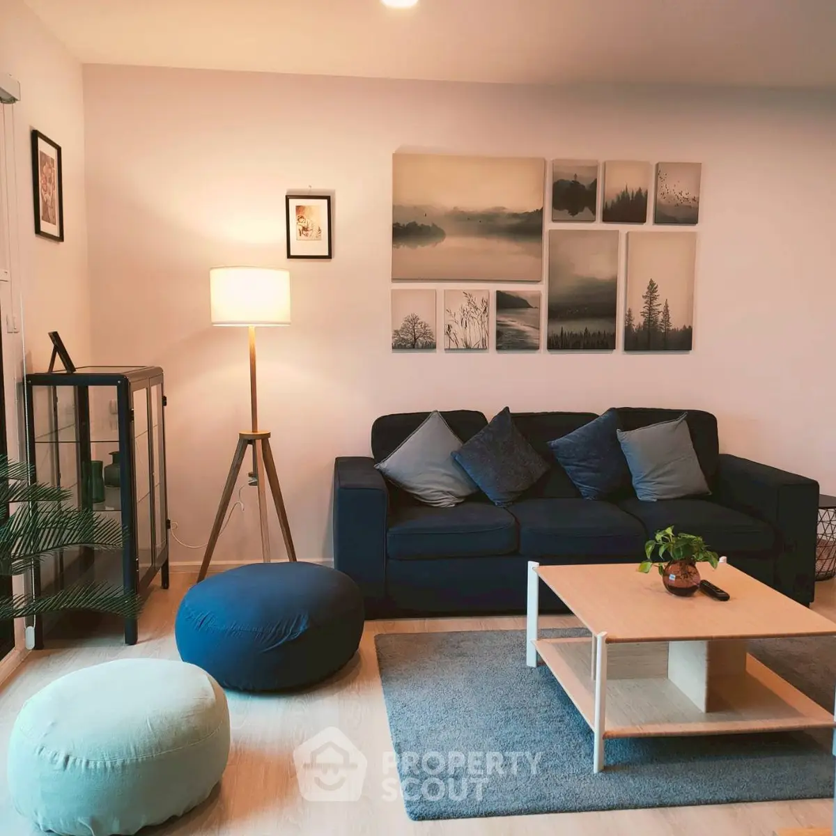 Stylish living room with modern decor, cozy seating, and elegant wall art for a welcoming ambiance.