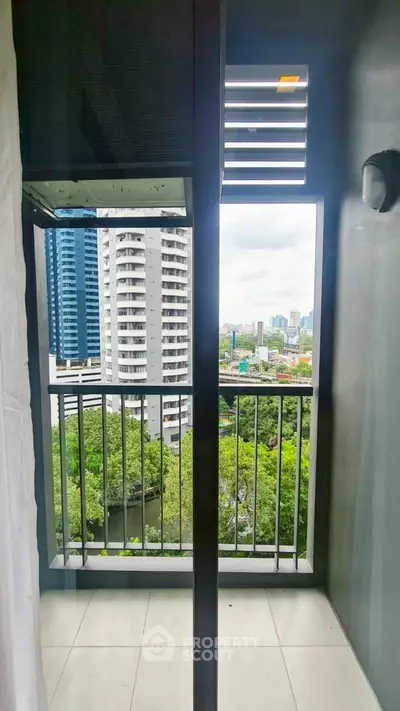 Modern apartment balcony with cityscape and lush greenery views