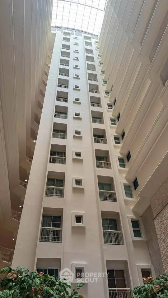 Stunning view of a modern high-rise building's interior atrium with natural light.