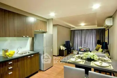 Modern open-plan kitchen and living room with stylish decor and wooden flooring.