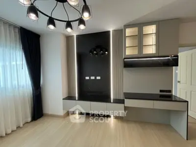 Modern living room with elegant lighting and built-in cabinetry