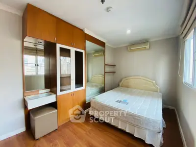 Spacious bedroom with built-in wardrobe and city view window