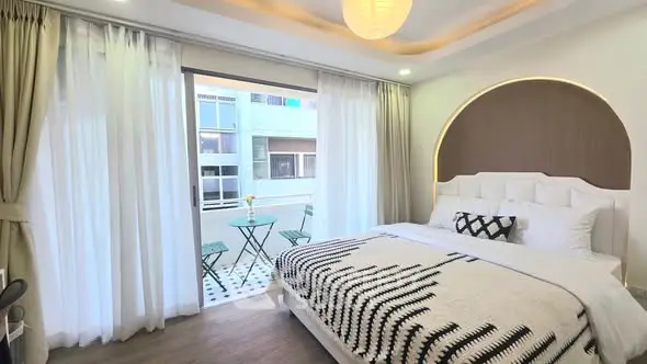 Luxurious bedroom with balcony access and elegant decor