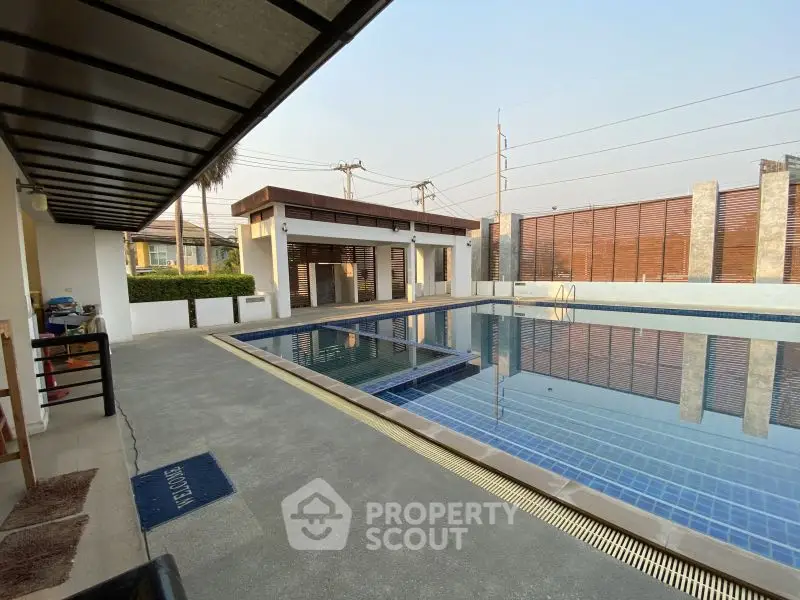 Luxurious outdoor pool area with modern design and spacious deck, perfect for relaxation and entertainment.