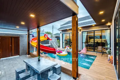 Luxurious modern home with private pool and slide, perfect for family fun and relaxation.