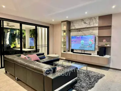 Luxurious modern living room with sleek leather sofa and stylish entertainment center.