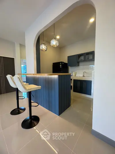 Modern kitchen with stylish breakfast bar and pendant lighting