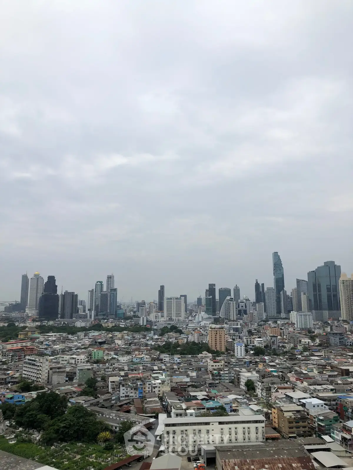 Stunning cityscape view of a vibrant urban skyline under a cloudy sky.