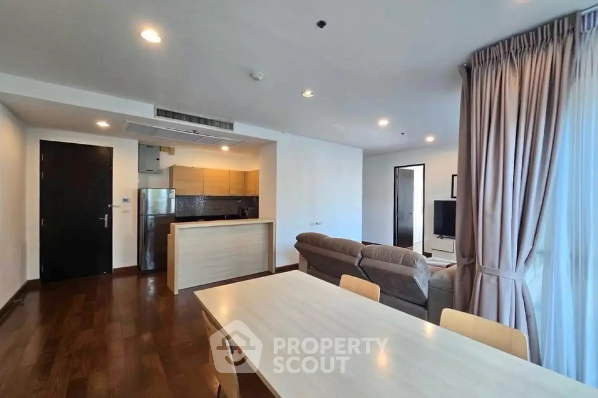 Spacious modern living room with open kitchen and cozy seating area