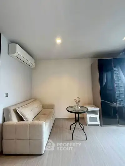 Modern living room with sleek sofa and air conditioning in stylish apartment.