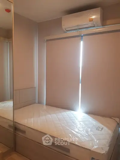 Cozy bedroom with air conditioning and mirrored wardrobe, perfect for comfort and style.