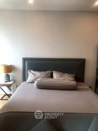 Cozy bedroom with stylish bed and modern lamp