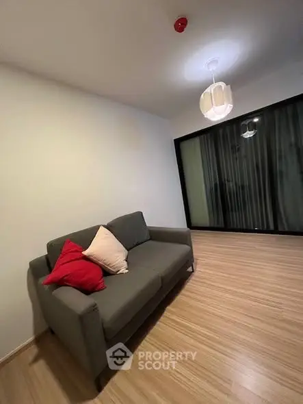 Modern living room with cozy sofa and stylish lighting, perfect for relaxation.