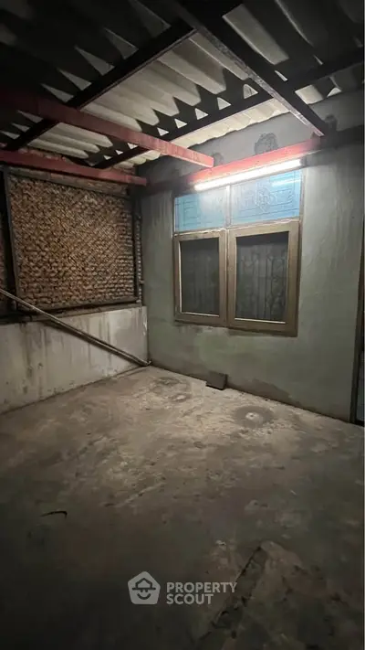 Spacious storage room with concrete floor and natural light