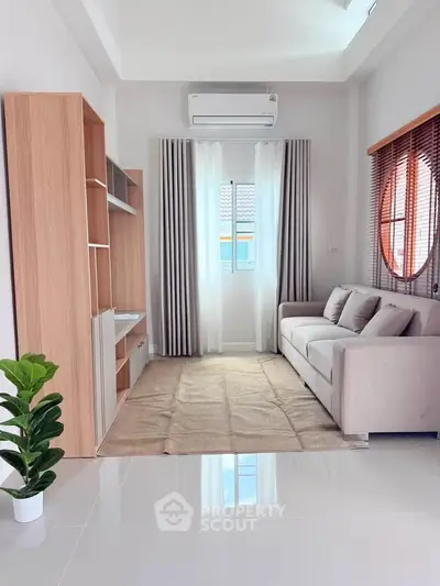 Modern living room with sleek furniture and natural light, perfect for relaxation and comfort.