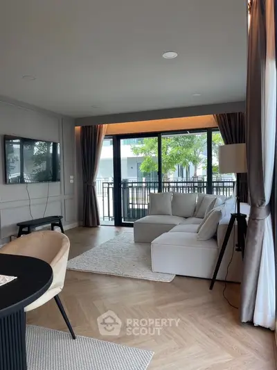 Spacious modern living room with large windows and elegant decor