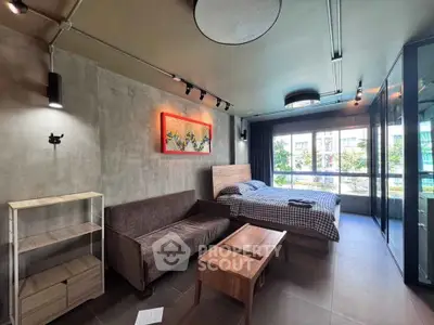 Modern studio apartment with stylish decor and large window view