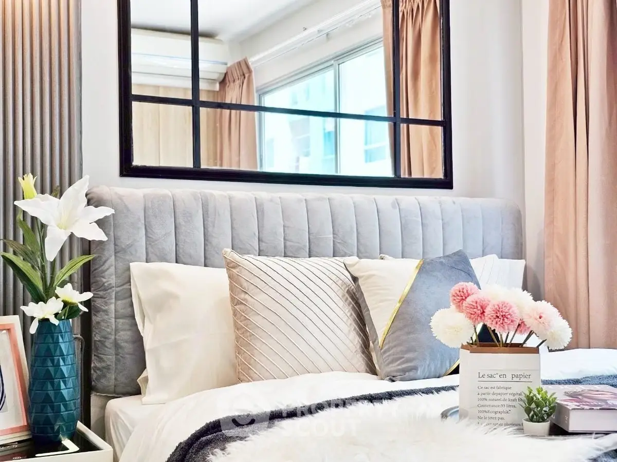 Luxurious bedroom with elegant decor and large mirror enhancing space.