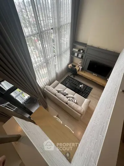 Stunning high-rise living room with floor-to-ceiling windows and modern decor, offering breathtaking city views.