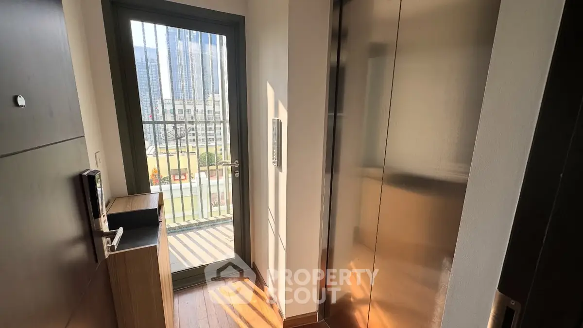 Modern apartment entrance with elevator access and city view