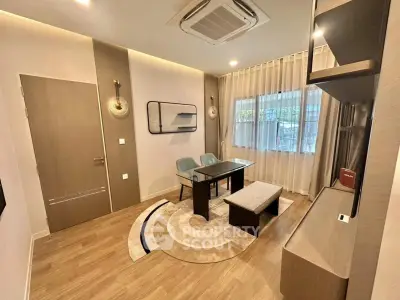 Modern living room with stylish furniture and elegant lighting, featuring a cozy dining area and large window.