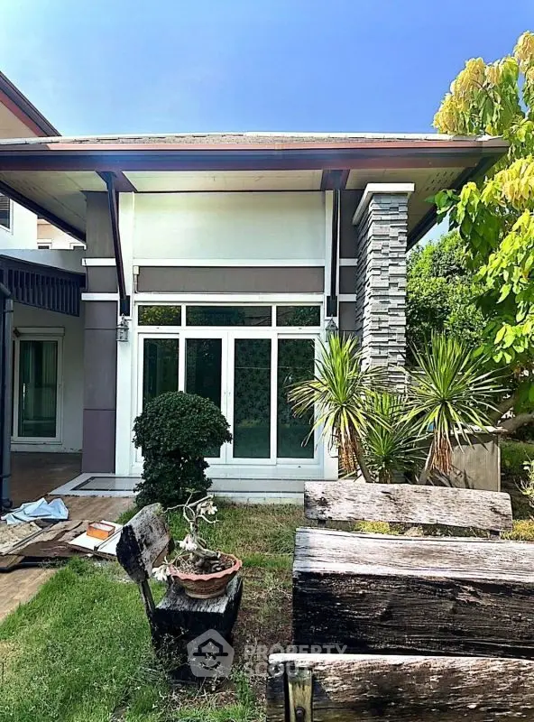 Charming modern home exterior with lush garden and stylish architecture