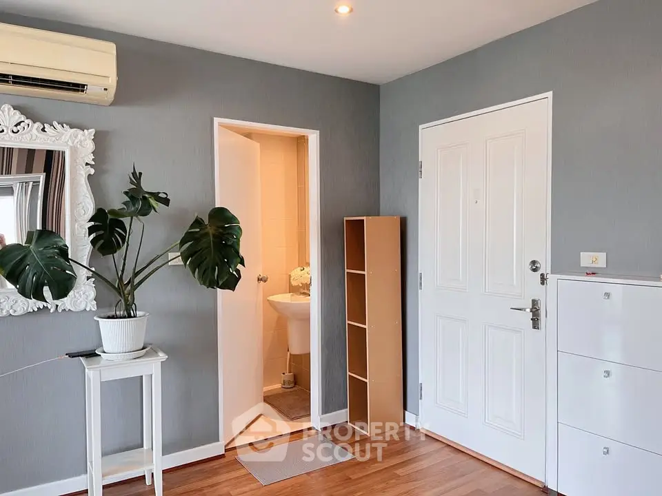 Modern apartment entrance with stylish decor and indoor plant