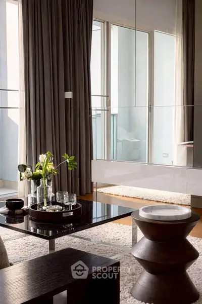 Stylish modern living room with elegant decor and large windows for natural light.