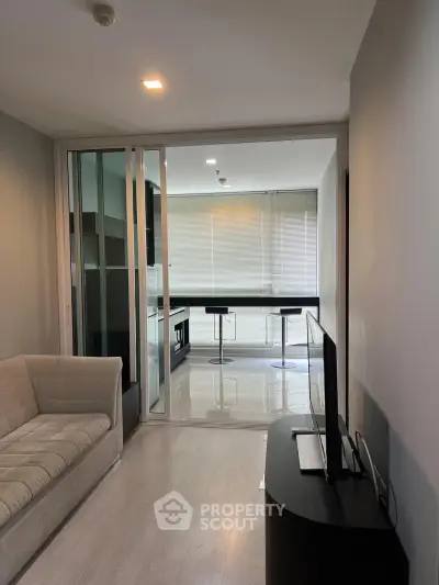Modern living room with sleek design and open layout, featuring a cozy sofa and stylish TV stand.