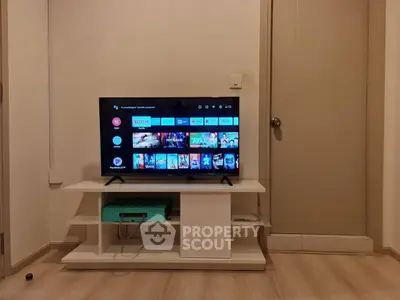 Modern living room with sleek TV stand and flat-screen TV displaying streaming apps.