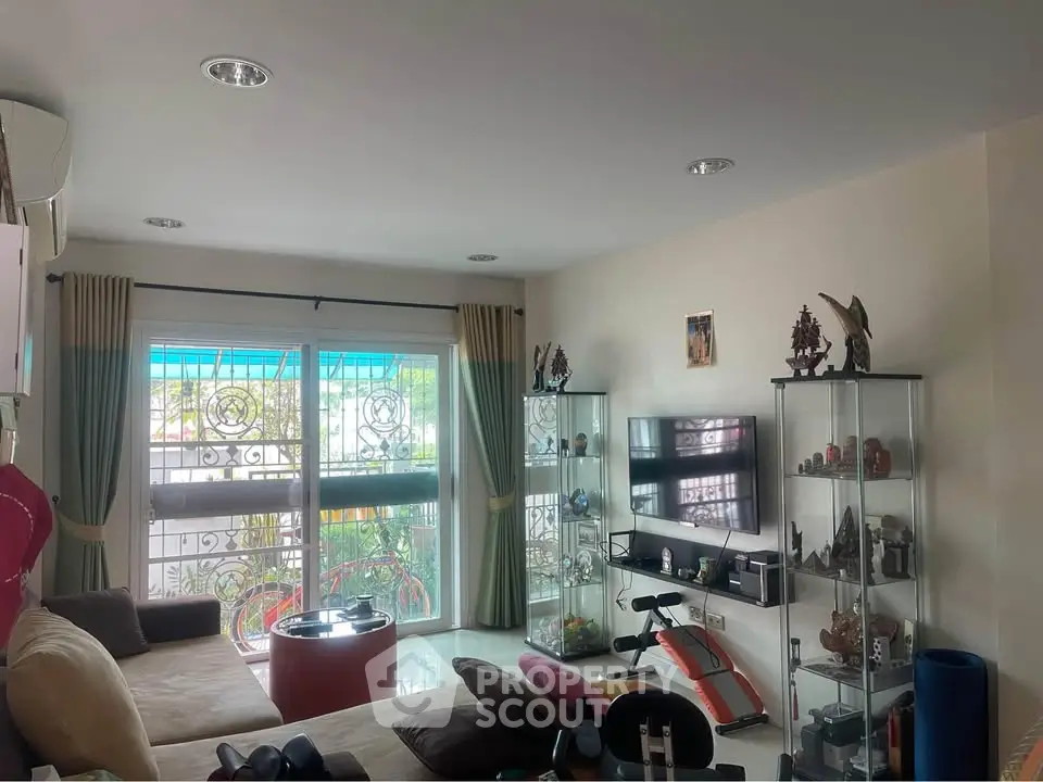 Spacious living room with modern decor and large windows for natural light.